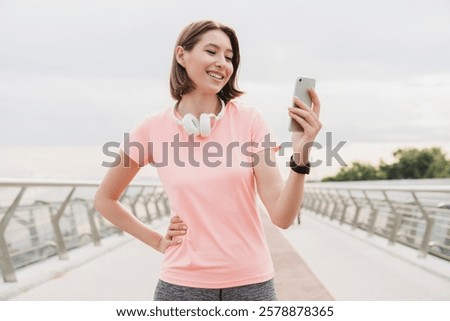 Similar – Image, Stock Photo Sportswoman in headset using social media on smartphone after workout