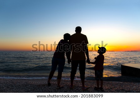 Family Silhouette. Sunset at sea.