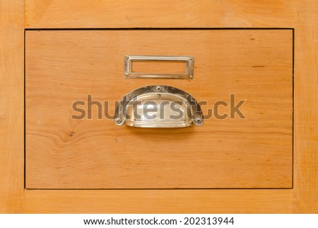 a single old cabinet drawer with metal handle and designation placeholder