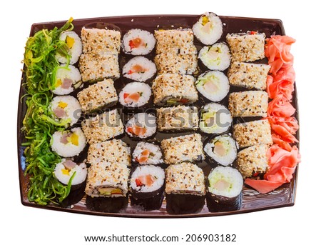 large plate with a wide selection of sushi, seaweed salad and pickled ginger