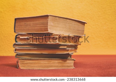 stack of old books in front of a colorful background