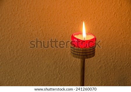 burning candle on a candle holder