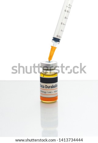 A syringe in a generic unbranded bottle of Deca Durabolin containing the active ingredient nandrolone decanoate used to treat osteoporosis, some types of anemia and breast cancer in women Сток-фото © 
