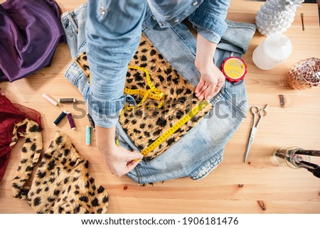 Fashion designer designing, customizing and upcycling clothes while working in workshop for conscious fashion project Photo stock © 