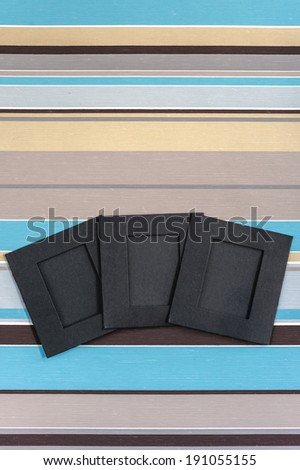 Blank photographs frames over colorful striped background