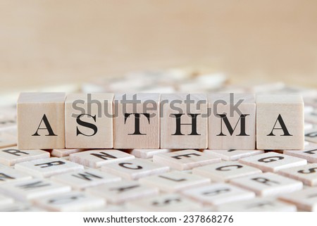 asthma word background on wood blocks