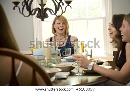 A group of young women eating lunch in a well-lit dining room
