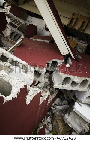 A demolished house with broken cement blocks