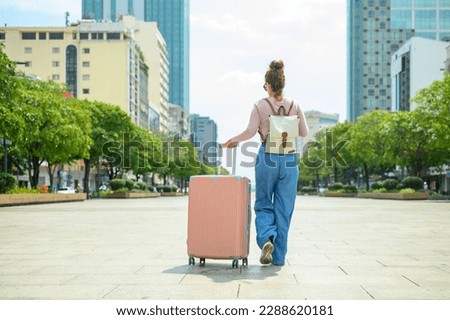 Image, Stock Photo Anonymous female with luggage walking in empty airport