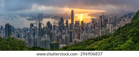 The cloud kept flowing over the hills until the sun rose and broke-through, turning Kowloon Bay golden and bathing the city in it\'s light. The cloud above and forest below provide the perfect frame.
