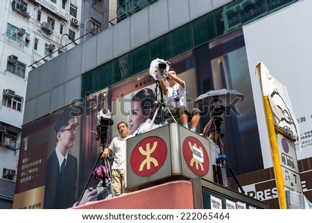 Hong Kong - October 5 2014: Occupy Central protest movement - TV reporter shoot people demonstrations in Mong Kok Station cover.