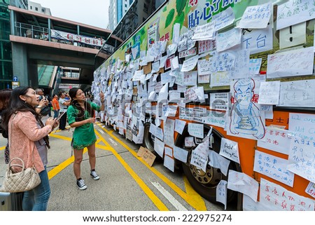 Hong Kong - September 30 2014: People around a empty bus in Mong Kok, Kowloon, Hong Kong. Occupy Central is a civil disobedience movement which began in Hong Kong on September 28, 2014
