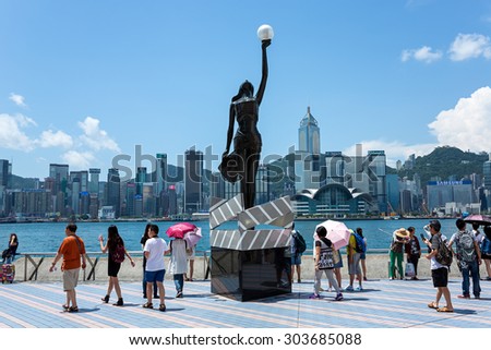Hong Kong, China - July 28 2015: Bronze statue of Hong Kong Film Awards and skyline in Avenue of Stars. The promenade honours celebrities of the Hong Kong film industry as the famous city attraction.