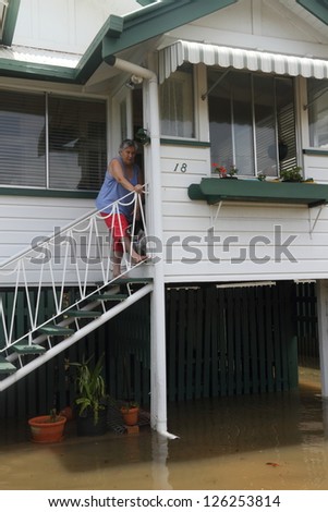 BRISBANE, AUSTRALIA - JANUARY 28 : Unidentified resident surveys flood damage from ex tropical cyclone Oswald on January 28, 2013 in Brisbane, Australia