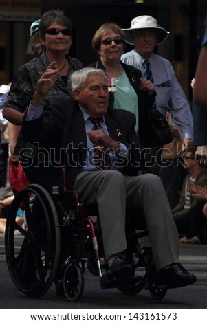 BRISBANE, AUSTRALIA - APRIL 25 : Veteran in wheelchair moving along march route during Anzac day commemorations  April 25, 2013 in Brisbane, Australia