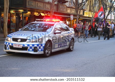 BRISBANE, AUSTRALIA - JULY 06 : Police escorting marchers during Bust The Budget anti liberal governement Rally July 06, 2014 in Brisbane, Australia