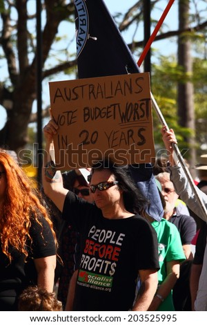 BRISBANE, AUSTRALIA - JULY 06 : Unidentified protester anti budget with sign at Bust The Budget anti liberal government Rally July 06, 2014 in Brisbane, Australia