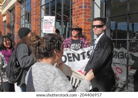 BRISBANE, AUSTRALIA - JULY 12 : Unidentified anti government protesters confronted by federal police outside Liberal National Party national conerfence July 12, 2014 in Brisbane, Australia