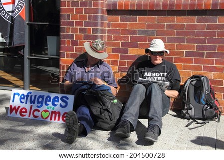 BRISBANE, AUSTRALIA - JULY 12 : Unidentified protesters with anti refugee policy sign outside Liberal National Party national conference July 12, 2014 in Brisbane, Australia