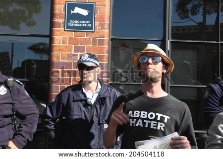BRISBANE, AUSTRALIA - JULY 12 : Unidentified anti government protester with abbott hater shirt outside Liberal National Party national conference July 12, 2014 in Brisbane, Australia