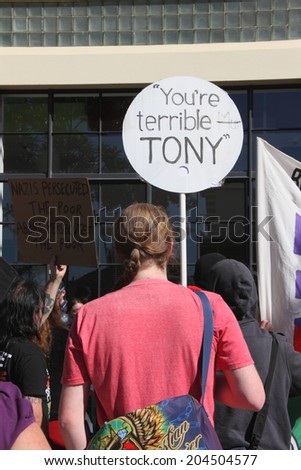 BRISBANE, AUSTRALIA - JULY 12 : Unidentified protesters with anti Tony Abbott sign outside Liberal National Party national conference July 12, 2014 in Brisbane, Australia