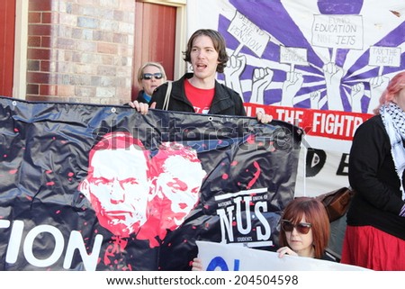 BRISBANE, AUSTRALIA - JULY 12 : Unidentified protesters with anti government signs outside Liberal National Party national conference July 12, 2014 in Brisbane, Australia