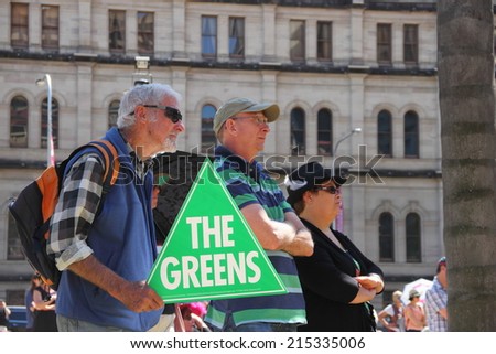 BRISBANE, AUSTRALIA - AUGUST 31: Unidentified protesters with pro Green party sign at March Australia Rally August 31, 2014 in Brisbane, Australia