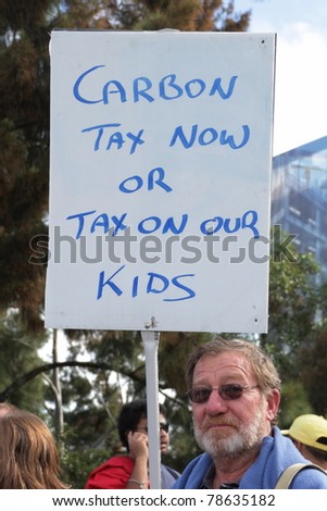 BRISBANE, AUSTRALIA - JUNE 6 : man with pro carbon tax sign during World Environment Day say yes protest 6, 2011 in Brisbane, Australia