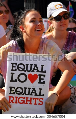 BRISBANE, AUSTRALIA - AUGUST 8 2015: Unidentified rally goers with equal love pro-gay marriage sign at Marriage Equality Rally August 8, 2015 in Brisbane, Australia