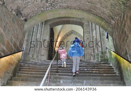 MONT SAINT MICHEL, FRANCE - JUNE 04, 2014: Tourists visiting Mont Saint Michel Abbey and fortifications in Normandy France