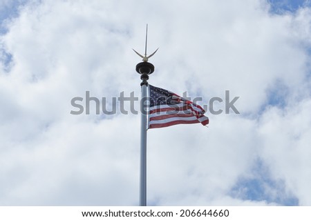 COLLEVILLE, FRANCE - JUNE 05, 2014: American flag at Normandy American Cemetery and Memorial