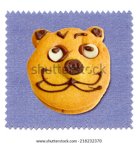 Vintage looking Baked cookie with cat face over blue tablecloth