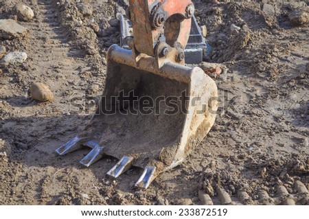Excavator mechanical shovel digger digging a hole in the ground
