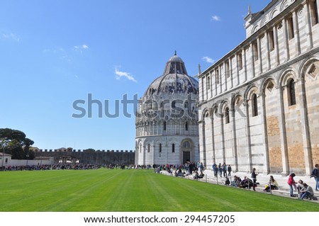 PISA, ITALY - : Tourists in front of the Baptistery of the Cathedral of Pisa in Italy