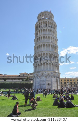 PISA, ITALY - APRIL 6, 2015: Tourists in front of the leaning Pisa Tower aka Torre di Pisa in Italy