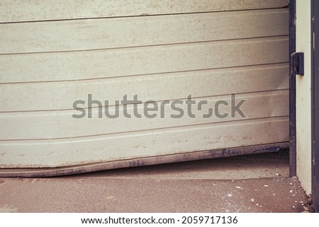 Damaged bent door that rises when opening a lift garage Stock foto © 