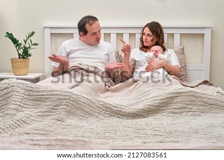 Ascertaining the paternity of a child between mother and father. Man and woman and with newborn baby in the bedroom Сток-фото © 