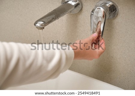 Similar – Foto Bild Wasserhahngriffe an der Wand im Badezimmer