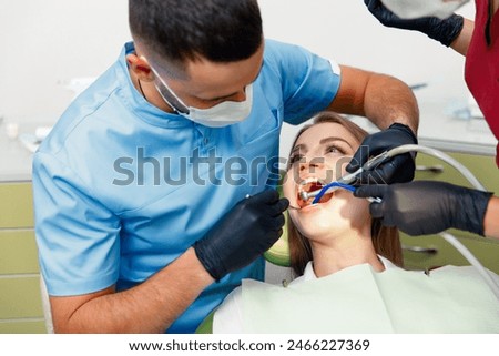 Image, Stock Photo Dentist treating teeth of patient with UV light