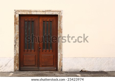Simple wooden door with a large empty wall next to it