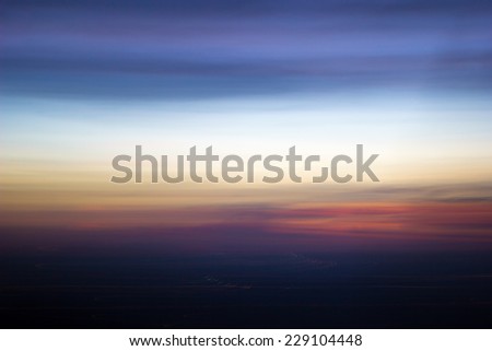 Abstract motion blur of sunset. Using motion blur from camera to blur photo to look like abstract background.
