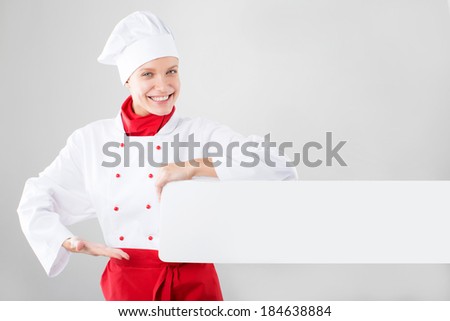 girl dressed as chef hands holding white banner