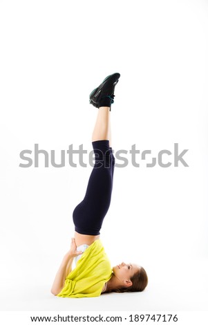 Flexible young woman doing a shoulder stand