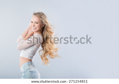 Portrait of the blonde with long wavy hair in the wind