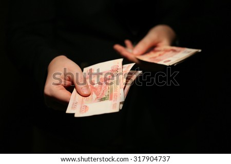 Close-up of a women hands counting Russian banknotes
