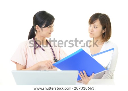 Smiling female nurse taking a health interview