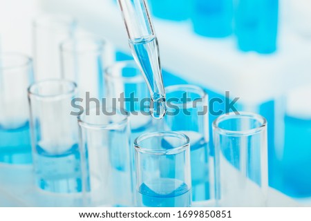 Laboratory glassware with a dropper dripping liquid into a test tube. scientific laboratory test tubes, laboratory equipment Stockfoto © 
