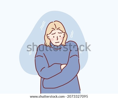 Freezing and shivering young girl on winter cold. Hand drawn style vector design illustrations. Foto stock © 