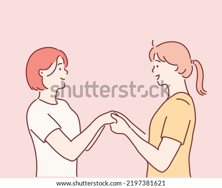 two girls holding each other by hands. Hand drawn style vector design illustrations.