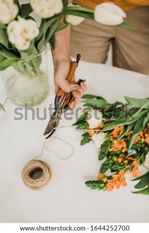 florist working with pruning shears orange flowers Сток-фото © 